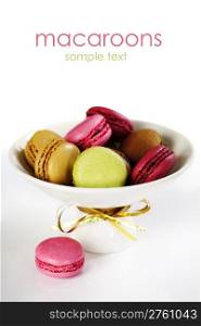 Colorful macaroons in a plate over white