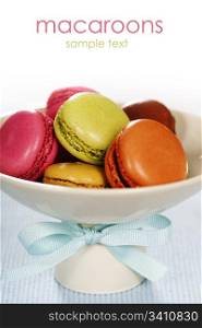 Colorful macaroons in a white plate (with sample text)