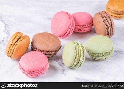 Colorful macaroons on marble background, top view vintage color style