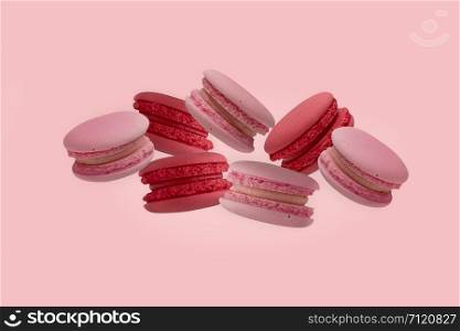 colorful macaroons on the pink background.