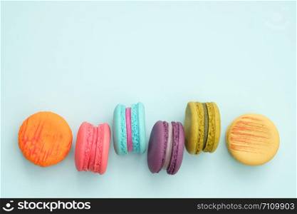 colorful macaroons on turquoise background, Sweet and tasty for cooking and restaurant menu, Dessert beautiful, Top view, Space to write. pastel colors, vintage card.