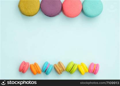 colorful macaroons on turquoise background, Sweet and tasty for cooking and restaurant menu, Dessert beautiful, Top view, Space to write. pastel colors, vintage card.