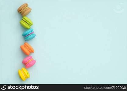 colorful macaroons on turquoise background, Sweet and tasty for cooking and restaurant menu, Dessert, Top view, Space to write. pastel colors, vintage card.