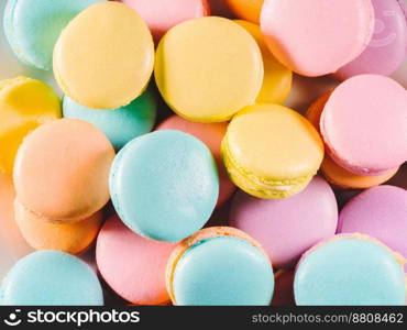 Colorful macaroons. Sweet macarons on retro dark background with copy space. Top view, Holiday time concept