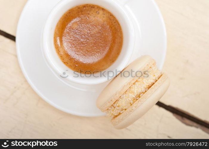 colorful macaroons with espresso coffee over white wood table