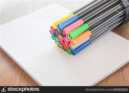 Colorful magic pens on sheet paper, stock photo