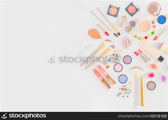 Colorful make up and brushes flat lay top view scene on white background. Colorful make up flat lay scene