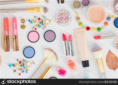 Colorful make up and brushes products flat lay pattern on white background. Colorful make up flat lay scene