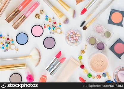 Colorful make up and brushes products flat lay scene on white background. Colorful make up flat lay scene