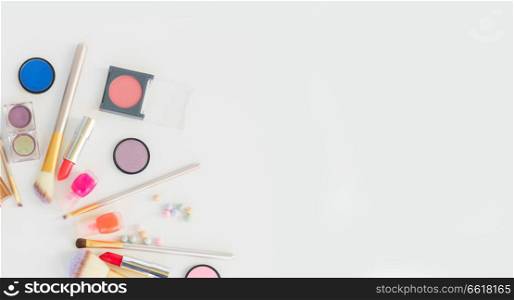 Colorful make up flat lay scene on white background. Colorful make up flat lay scene