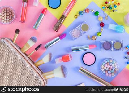 Colorful make up products with golden pursue close up material design flat lay scene. Colorful make up flat lay scene