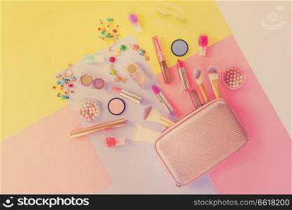 Colorful make up products with golden pursue pop art flat lay scene, retro toned. Colorful make up flat lay scene
