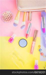 Colorful make up products with pursue pop art flat lay scene, retro toned. Colorful make up flat lay scene