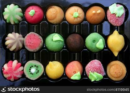 Colorful marzipan sweets with fruits shapes