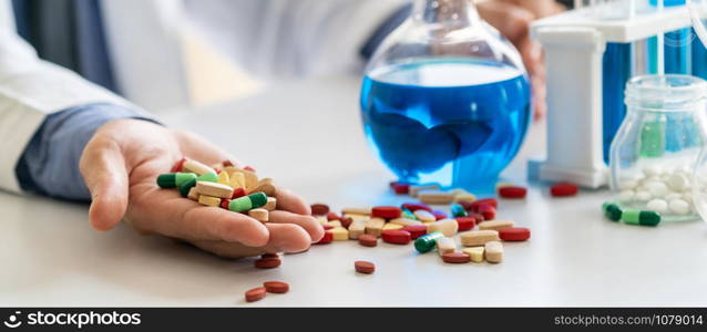 Colorful medicine pills and tablets in pharmaceutical lab. Concept of medical technology research and development for future cure of illness.