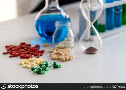 Colorful medicine pills and tablets in pharmaceutical lab. Concept of medical technology research and development for future cure of illness.