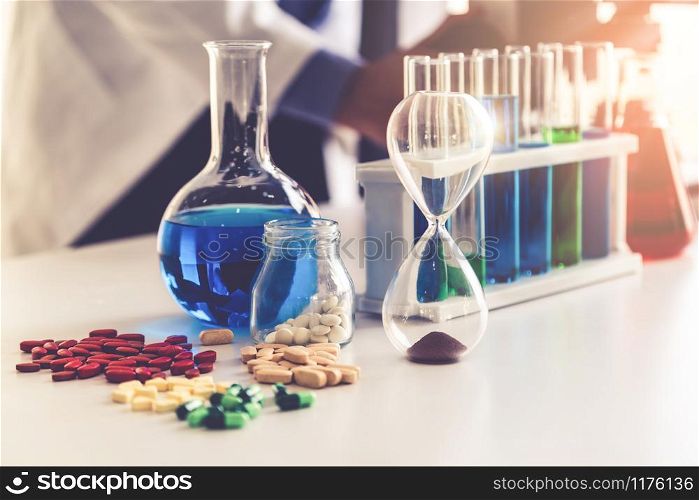 Colorful medicine pills and tablets in pharmaceutical lab. Concept of medical technology research and development for future cure of illness.