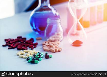 Colorful medicine pills and tablets in pharmaceutical lab. Concept of medical technology research and development for future cure of illness.