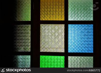 Colorful mosaic stained glass window. Multicolor glass window.