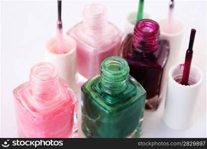 Colorful nail polishes isolated on gray background.