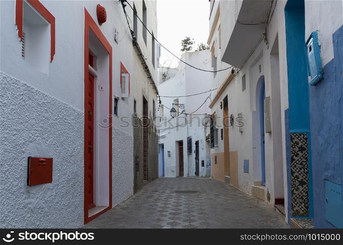 Colorful narrow old street in the medina of Asilah, Morocco