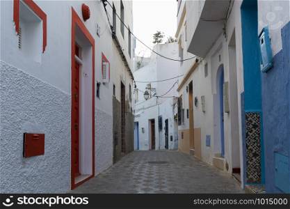 Colorful narrow old street in the medina of Asilah, Morocco