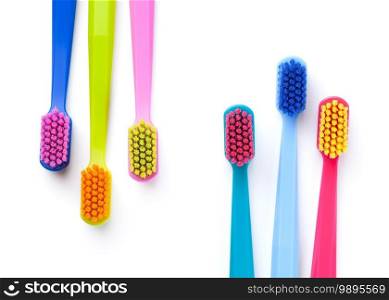 Colorful new toothbrushes isolated on white background. Top view