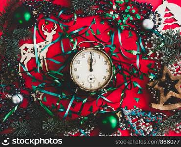 Colorful New Year and Christmas decorations, silver beads, branches of the Christmas tree on a red surface. Top view, close-up, flat lay. Greeting card. Colorful New Year and Christmas decorations, . Greeting card