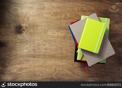 colorful notebook at wooden background . colorful notebook at wooden background texture