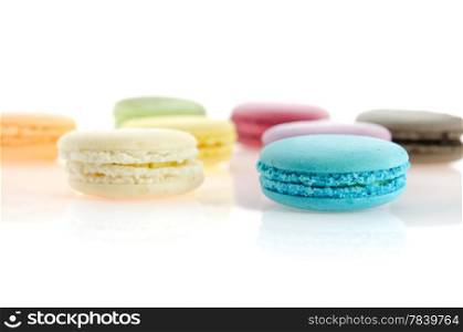colorful of french macaroons over white with reflection