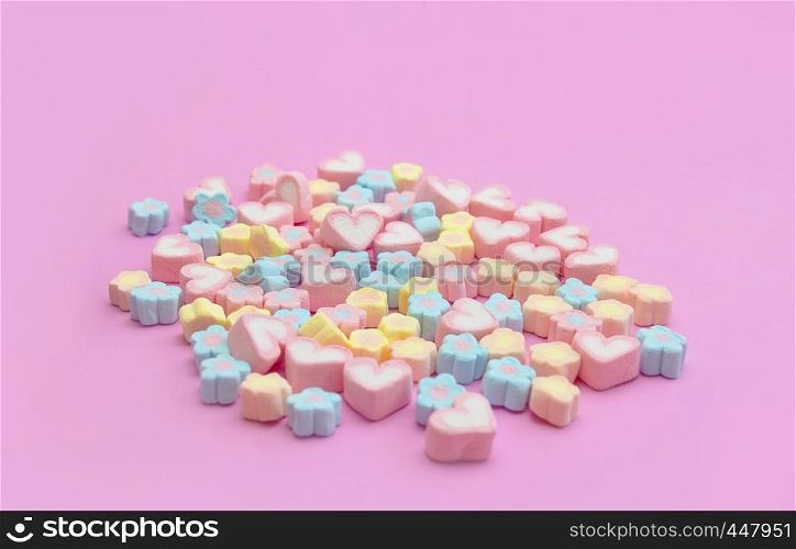 Colorful of mixing marshmallows sweet dessert with heart and flower shaped on pink background with copy space for web banner, advertisement, brochure, recipe menu design