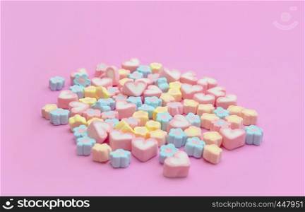 Colorful of mixing marshmallows sweet dessert with heart and flower shaped on pink background with copy space for web banner, advertisement, brochure, recipe menu design