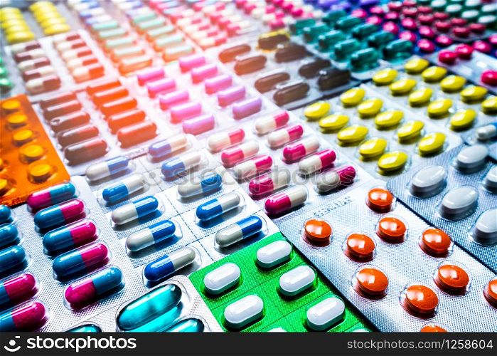 Colorful of tablets and capsules pill in blister packaging arranged with beautiful pattern with flare light. Pharmaceutical industry concept. Pharmacy drugstore. Antibiotic drug resistance.