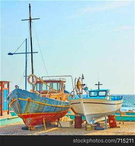 Colorful old fishing boats on dry boat parking in Ayia Napa, Cyprus