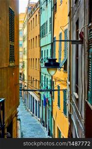 Colorful old narrow side street in Genoa city, Italy