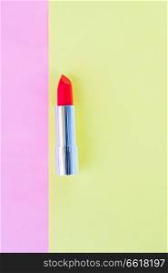 Colorful open red lipstick pop art flat lay scene. Colorful make up flat lay scene