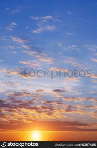 Colorful orange and blue sunset sky background at morning time in vertical frame