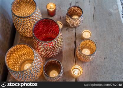 colorful orange candle holders on wooden table arabic design sparkles. colorful orange candle holders on wooden table arabic design