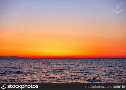 Colorful orange sky and the sea at sunset - seascape and background with space for your own text
