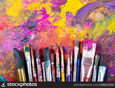 colorful paint brushes on a palette