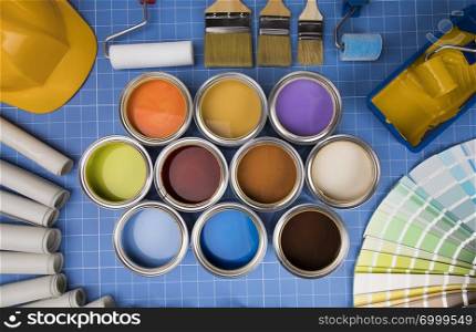 Colorful paint can,brush, blue background