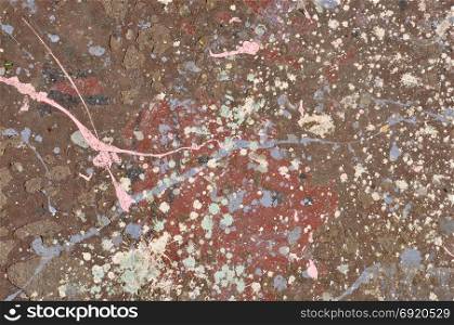 Colorful paint drips on peeling wall abstract artistic background texture.