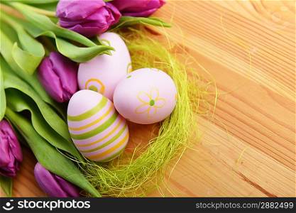 Colorful painted easter eggs and bouquet tulip