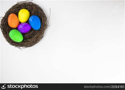 Colorful painted Easter Eggs isolated on white background with nest.Top view Happy Easter Holiday copy space space for text. Colorful painted Easter Eggs isolated on white background with nest.Top view Happy Easter Holiday copy space