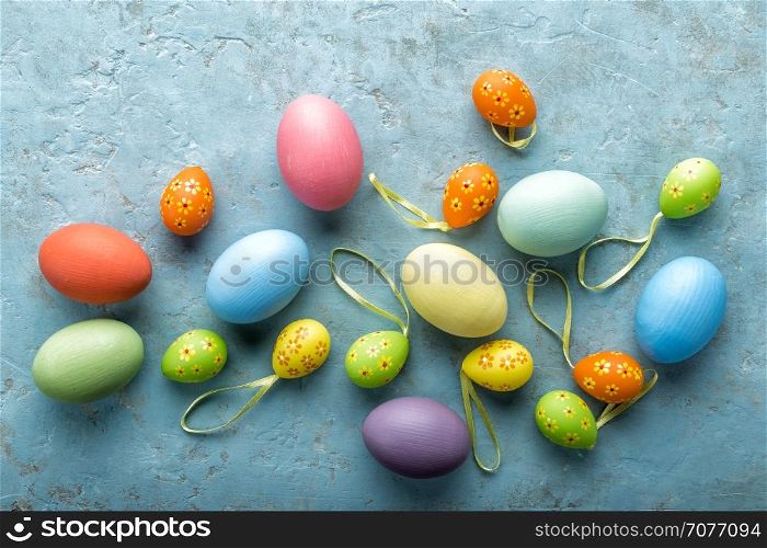 colorful painted Easter eggs on a light stone background