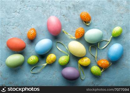 colorful painted Easter eggs on a light stone background