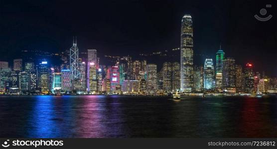 Colorful panoramic view of Hong Kong skyline on night time seen from Kowloon. Hong Kong, China.. Colorful panoramic view of Hong Kong skyline on night time seen from Kowloon.