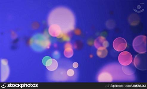 Colorful particles on blue background