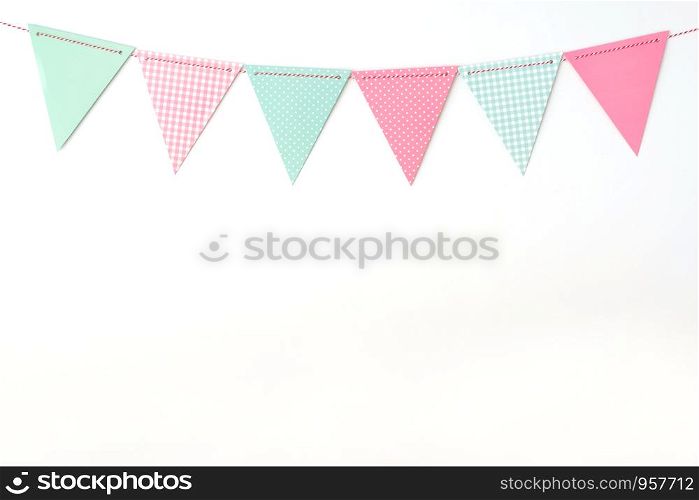 Colorful party flags hanging on white wall background, birthday, anniversary, celebrate event, festival greeting card background