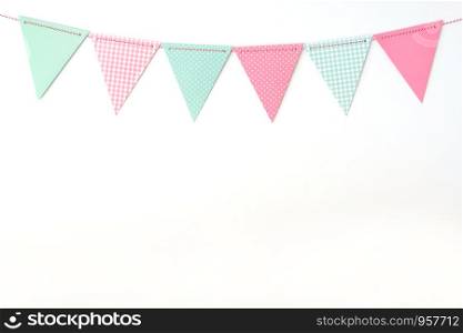 Colorful party flags hanging on white wall background, birthday, anniversary, celebrate event, festival greeting card background